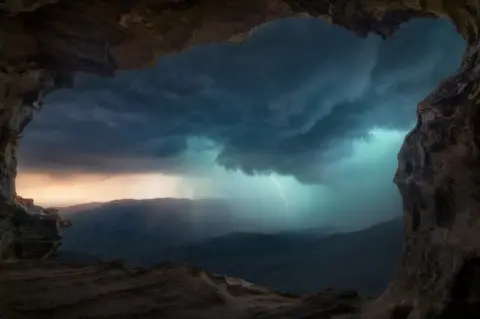 Benjamin Maze A mountainous landscape with lightning in the background