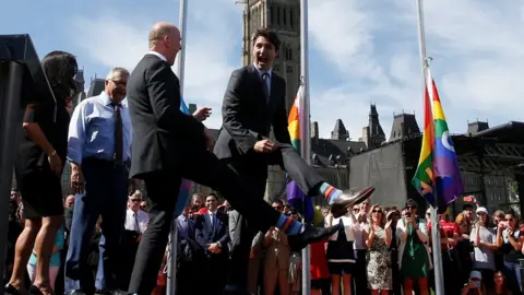 Reuters Canada's Prime Minister Justin Trudeau compares socks with Liberal MP Randy Boissonnault during a pride flag raising ceremony on Parliament Hill in Ottawa, Ontario, 25 June 2017