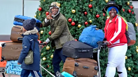 Reuters A family with suitcases at Gatwick