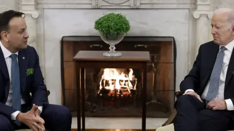 Getty Images President Joe Biden and Irish Taoiseach Leo Varadkar talk to journalists before their meeting in the Oval Office of the White House in 2023