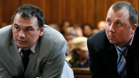 Reuters Farmers Willem Oosthuizen and Theo Martins (R) in court on 23 October 2017