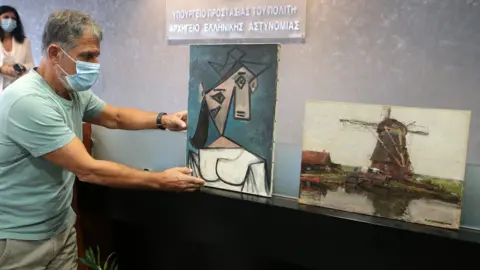 EPA Greek Police officers present the stolen Picasso and Mondrian paintings, at a press conference, in Athens, Greece, 29 June 2021