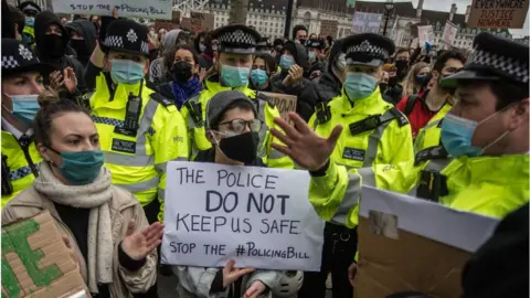 Getty Images Protestors demonstrate outside Scotland Yard over the treatment of people by police at the Sarah Everard vigil