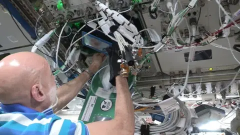 PA Media Luca Parmitano baking cookies on board the International Space Station