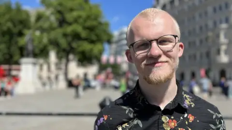 BBC News Sam Stevens smiles at the camera