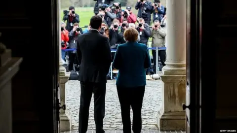 Getty Images Leo Varadkar and Angela Merkel pose for photos following talks in Dublin