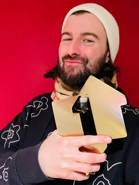 Official Charts Liam Fray with an Official Charts Award