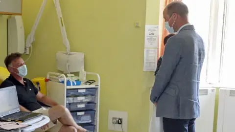 PA Media A volunteer taking part in the trial and William