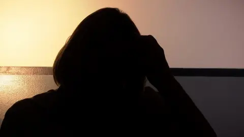 Silhouette of domestic abuse survivor