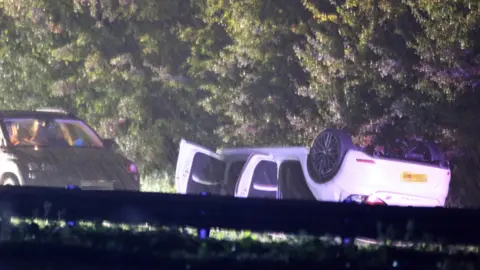 Eddie Mitchell Overturned car