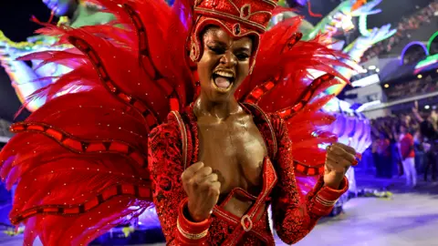 A reveller from Viradouro samba school performs during the night of the Carnival parade at the Sambadrome, in Rio de Janeiro, Brazil February 13, 2024.