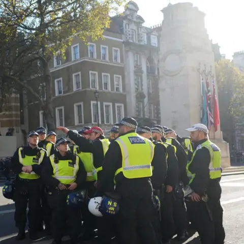 PA Media Police officers take their positions by the Cenotaph in Whitehall on Saturday morning