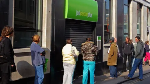 Getty Images people queue outside jobcentre