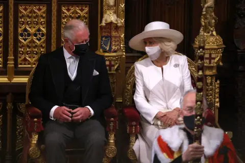 PA Media The Prince of Wales and the Duchess of Cornwall seen as Queen Elizabeth II delivers a speech from the throne in House of Lords at the Palace of Westminster in Londo