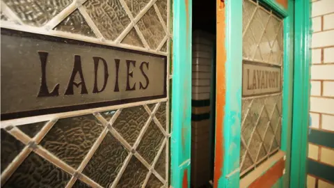 PA Media The doors to the ladies' lavatories in the gala pool area of Moseley Road Baths