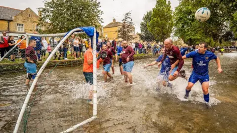 PA Media Bourton-on-the-Water football in the river