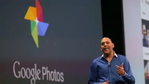 Getty Images Anil Sabharwal stands on stage announcing Google Photos in May 2018