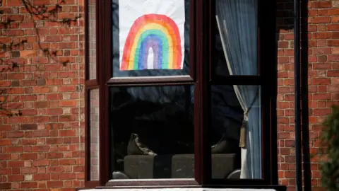 Reuters A hand-drawn picture of a rainbow is seen in a window in Liverpool, as the spread of coronavirus disease (COVID-19) continues. Liverpool, Britain