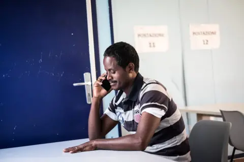 Marco Panzetti Tesfu speaks on the phone