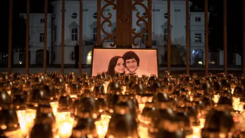 EPA Candles are placed during a march in memory of murdered Slovak journalist Jan Kuciak in front of the Slovak government building