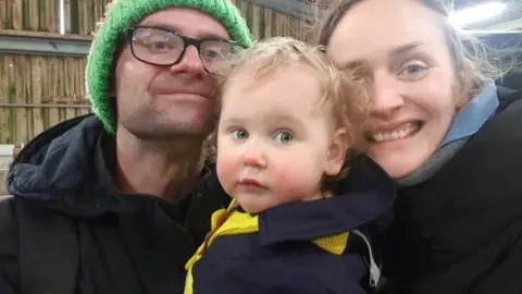 Handout/BHF Chris and Nicola Monk with their child