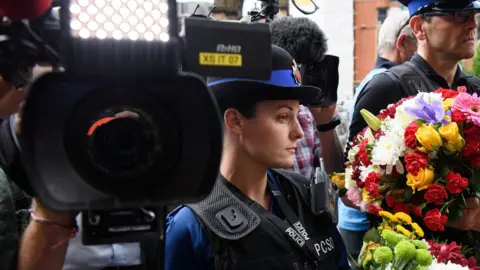 Getty Images A camera captures a memorial service in Manchester in May 2017