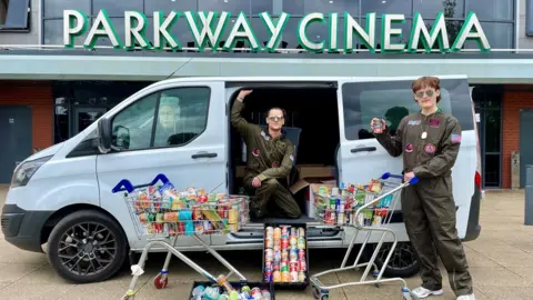 Richard Parkes Staff dressed up as Top Gun pilots to deliver the donations to food banks