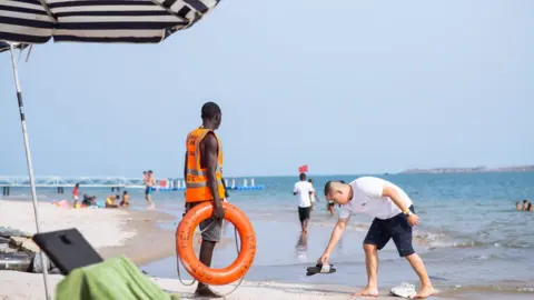 BBC A lifeguard on a beach in Lagos, Nigeria