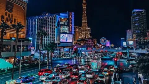 Getty Images The Las Vegas strip at night with cars lined up on the road