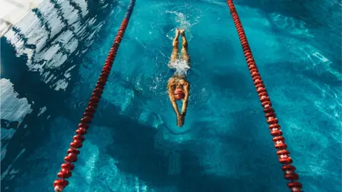 Getty Images A woman swimming in a pool lane