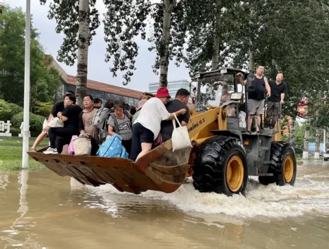 BBC Residents rescued on a bulldozer