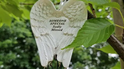 Family photograph A windchime hanging on a tree