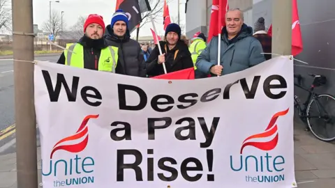 Pacemaker Striking Translink workers with a 'We Deserve A Pay Rise' sign