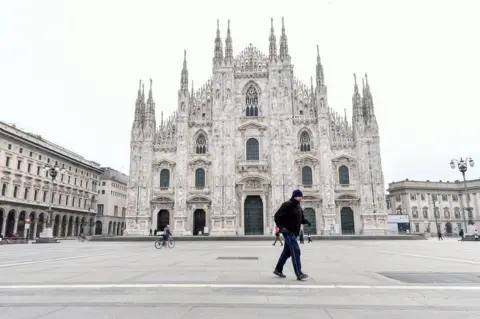 Reuters A man walks in Duomo square in Milan