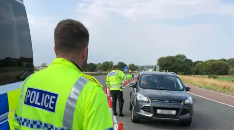 Lancashire Police Police officers handing out water