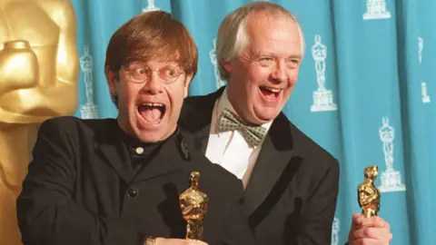 Getty Images Elton John and Tim Rice with their Oscar trophies in 1995