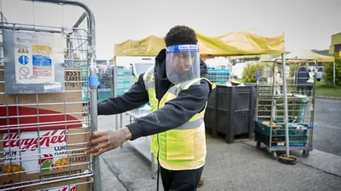 PA Media Marcus Rashford working at a food bank