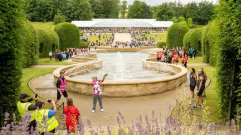 Getty Images Jenny Thomas pictured with the baton at Alnwick Gardens