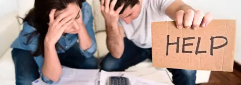 Getty Images Man and woman in financial difficulty