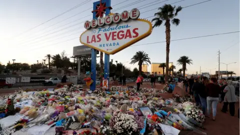 Reuters The "Welcome to Las Vegas" sign is surrounded by flowers and items, left after the October 1 mass shooting, in Las Vegas, Nevada U.S. October 9, 2017.
