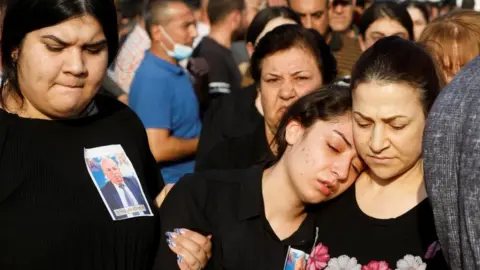 Reuters Mourners at a funeral of a victim of the fire (27/09/23)