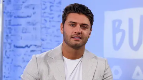 Getty Images Mike Thalassitis, who was on Love Island in 2017, during a panel discussion in February 2018