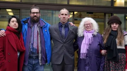 PA Media Former Team GB athlete Etienne Stott (centre) and his co-accused Amy Rugg-Easey, 32, Nichola Andersen, 50, Erika Curren, 65, and Shaun Davies, 32