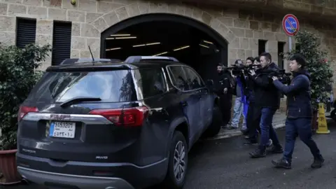 Getty Images Photographers chase a car