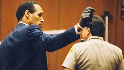 Getty Images OJ Simpson shows jury a leather glove allegedly used in the murders