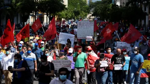 Reuters Protesters holding flags and banners march in Guayaquil