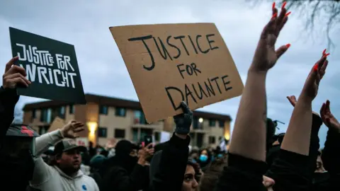 Getty Images Protestors near Minneapolis holding up banners