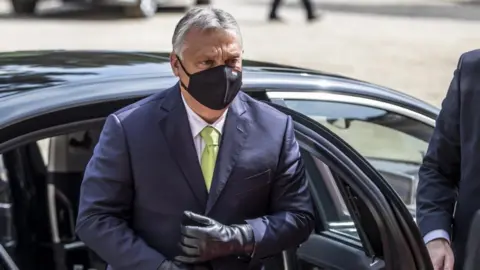 EPA Viktor Orban in a face mask exiting a car
