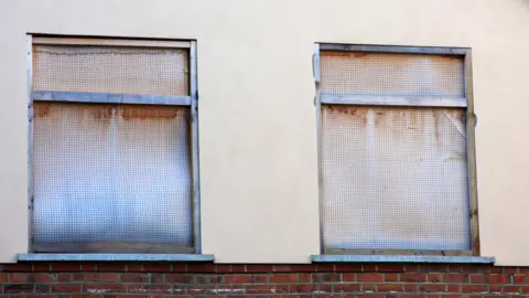 BBC General exterior view of an empty and derelict detached house