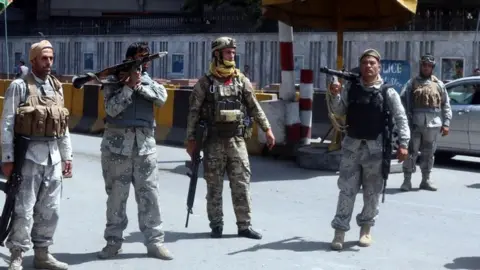 EPA Afghan security officials stand guard at a checkpoint in Kabul, Afghanistan, 15 August 2021